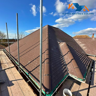 Professional roofer working on a pitched roof in Cheltenham